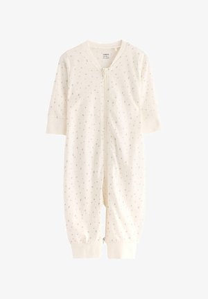Roomkleurige baby rompertje van zacht materiaal, met een ritssluiting aan de voorkant en een lichtgrijs stippenpatroon, met lange mouwen en elastische manchetten.