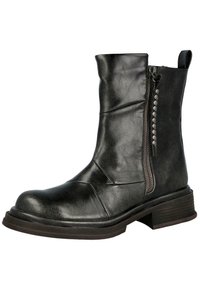 Botín negro de cuero hasta el tobillo con cremallera lateral, superficie texturizada y tachuelas decorativas. Presenta un tacón grueso y punta redondeada.