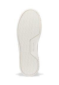 Valkoinen kumikenkä, jonka pohjassa on timantin muotoinen uritus ja "Cole Haan" -logo mahdollisimman lähellä kaarialuetta, esitetty valkoista taustaa vasten.