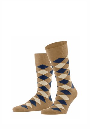 Bruine sokken met een diamanten patroon in crème en marineblauw, gemaakt van textuurer stof met een geribbelde boord voor een stevige pasvorm.