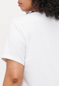 White t-shirt with a round neckline and short sleeves, featuring a smooth texture and a simple, classic design.