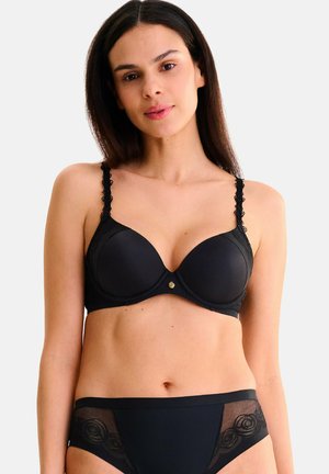 Soutien-gorge noir avec bonnets rembourrés et bretelles en dentelle festonnée, orné d'un détail central en métal doré. Culotte taille haute assortie avec accents transparents.