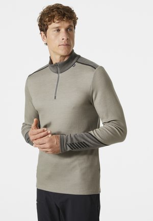 Lichtgrijze langarmshirt met een halve rits kraag, contrasterende donkergrijze manchetten met een subtiel gestreept patroon. Gelaagde stofontwerp.