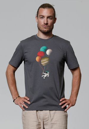 Grijze katoenen T-shirt met een illustratie van een astronaut die kleurrijke ballonnen in de vorm van planeten vasthoudt. Korte mouwen en een klassiek ronde halsontwerp.
