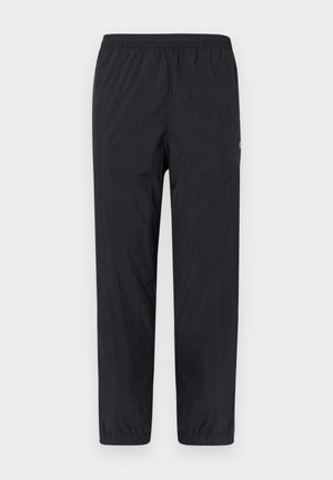 Schwarze, leichte, elastische Hose mit schmal zulaufenden Beinen und minimaler Textur. Mit seitlichen Nähten und einem kleinen Logo am linken Bein.