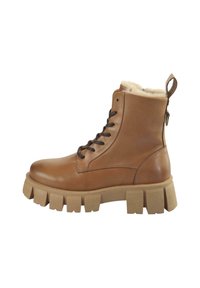 Bottes chelsea en cuir marron avec une doublure en fausse fourrure confortable, une semelle épaisse beige et des lacets à l'avant pour un ajustement personnalisable. Bande latérale pour un enfilage facile.