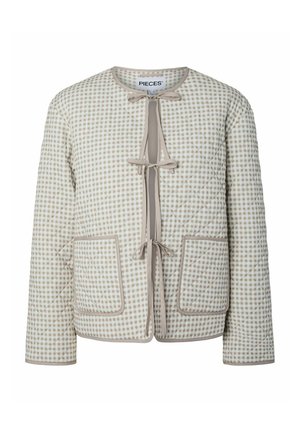 Veste matelassée beige et blanche avec motif à carreaux, trois fermetures à nouer sur le devant, deux grandes poches avant et encolure ronde.
