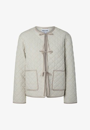 Veste matelassée beige et blanche avec motif à carreaux, trois fermetures à nouer sur le devant, deux grandes poches avant et encolure ronde.