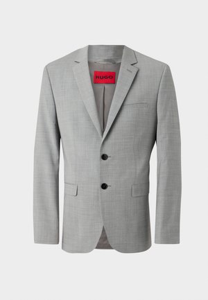 Grå kavaj i texturerad tyg, med två svarta knappar, en enkel bröstficka och en röd innermärkning med texten "HUGO."