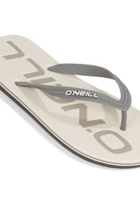 Ciabatta leggera beige chiaro con superficie testurizzata, cinturini in gomma grigia e logo "O'Neill". Presenta un design privo di PVC e un colore della suola contrastante.