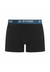 Czarne bokserki z jednolitym designem, z niebieskim elastycznym pasem w talii ozdobionym białym napisem "G-STAR". Gładka tekstura, dopasowany krój.