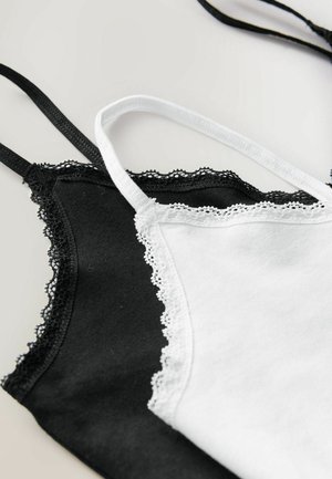 Black and white camisoles with lace trim, featuring adjustable straps and a smooth cotton texture. They are laid next to each other.