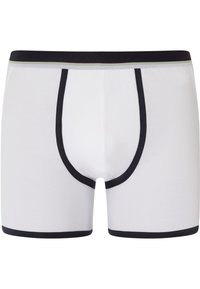 Valkoiset bokserit mustalla joustovyötäröllä. Niissä on erottuva musta reunus lahkeiden aukkojen ja pussin ympärillä tukevuutta varten.
