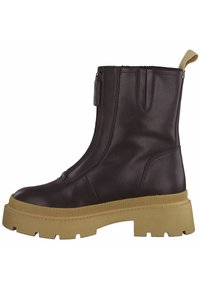 Bottine en cuir marron avec fermeture éclair sur le côté, semelle en caoutchouc texturée et design minimaliste. Dispose d'une petite languette au talon.