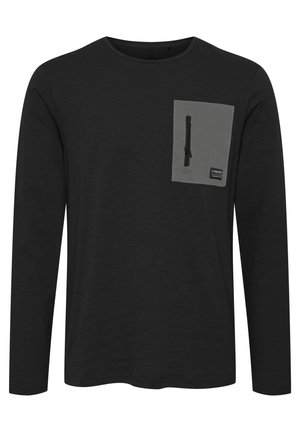 Black long-sleeve shirt featuring a gray chest pocket with a zipper and a fabric tag. The texture appears smooth and slightly heathered.