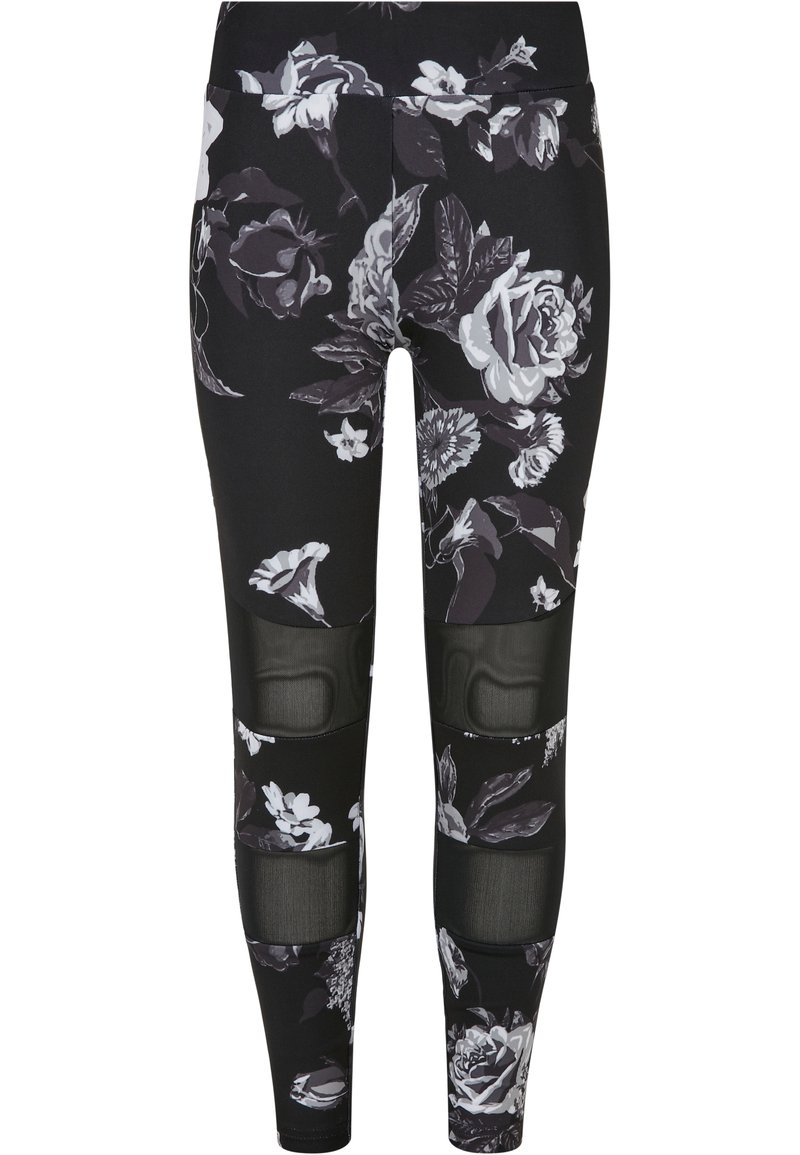 Svart leggings med et blomsterdesign i hvit og grå, med nettpaneler ved knærne for ekstra tekstur og designdetalj.