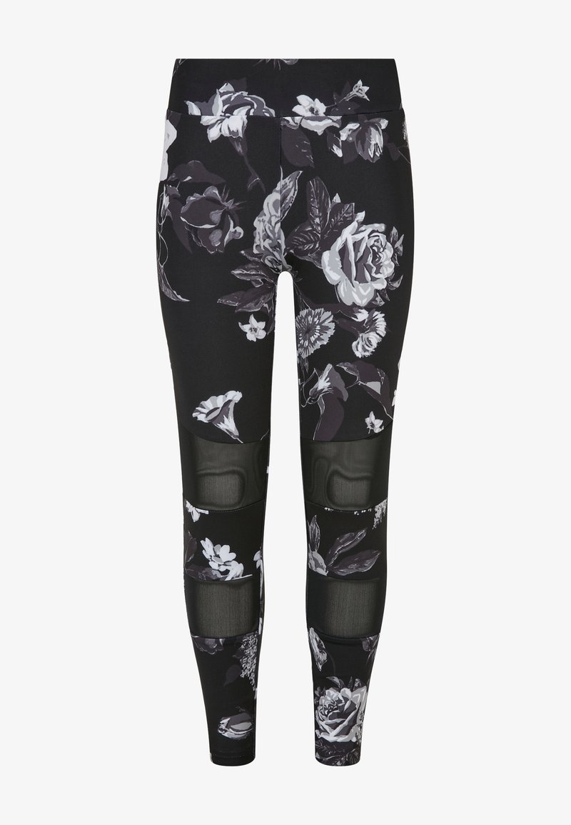 Svart leggings med et blomsterdesign i hvit og grå, med nettpaneler ved knærne for ekstra tekstur og designdetalj.