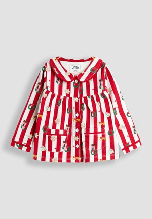 Piros és fehér csíkos, hosszú ujjú ing gallérral, ünnepi mintákkal, mint például koszorúk, zoknik és csillagok. Négy gomb és zsebek találhatók rajta.