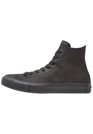 Czarny sneaker na wysokiej cholewce z fakturowaną wierzchnią częścią, czarnymi sznurowadłami i gumową podeszwą, widziany od zewnętrznej strony na białym tle.