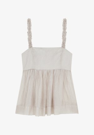 Jasno beżowa bezrękawnik z teksturowanej tkaniny, falbaniaste ramiączka i rozkloszowany fason. Posiada gładką, marszczoną część spódnicy.