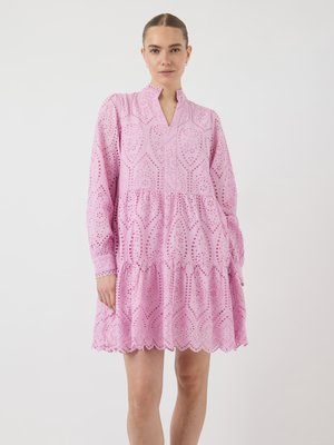 Pink cotton dress with long sleeves, a ruffled hem, and a mandarin collar. Features cut-out patterns and scalloped edges.