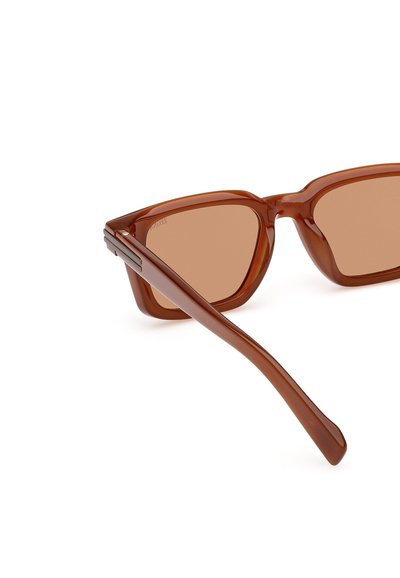 Brown plastic sunglasses with a geometric frame, light brown lenses, and thin, sleek temples. Smooth texture with angled edges.
