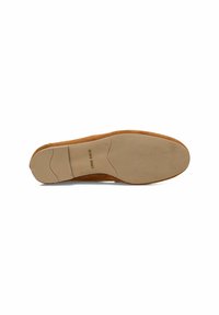 Brown suede shoe sole with a flexible tan rubber outsole, featuring a textured surface and embossed branding, designed for comfort and traction.