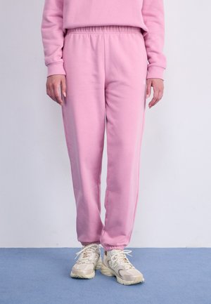 New Balance SPORT ESSENTIALS JOGGER - Tracksuit bottoms - pink