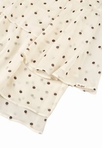 Herkules kerma bluse med brune og beige prikker. Flydende stof, lagdelt design og en lille mærkat på kanten med "Oh April."