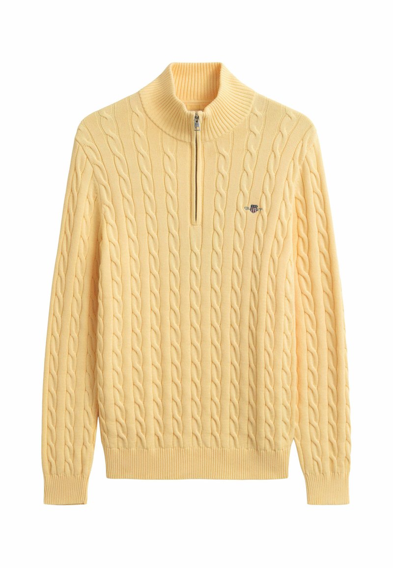 Yellow cable knit sweater with half-zip collar and small embroidered logo on the left chest, long sleeves, and ribbed cuffs and hem.