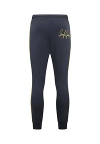 Marineblauwe sportbroek met een slim fit, elastische tailleband en geribbelde boorden. Bevat een gouden logo en zijstrepen. Zachte stoftextuur.