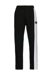 Black and white jogger pants with an elastic waistband, featuring a graphic print on the left thigh and a sleek, modern cut.