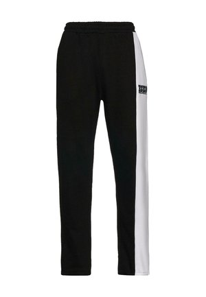 Black and white jogger pants with an elastic waistband, featuring a graphic print on the left thigh and a sleek, modern cut.