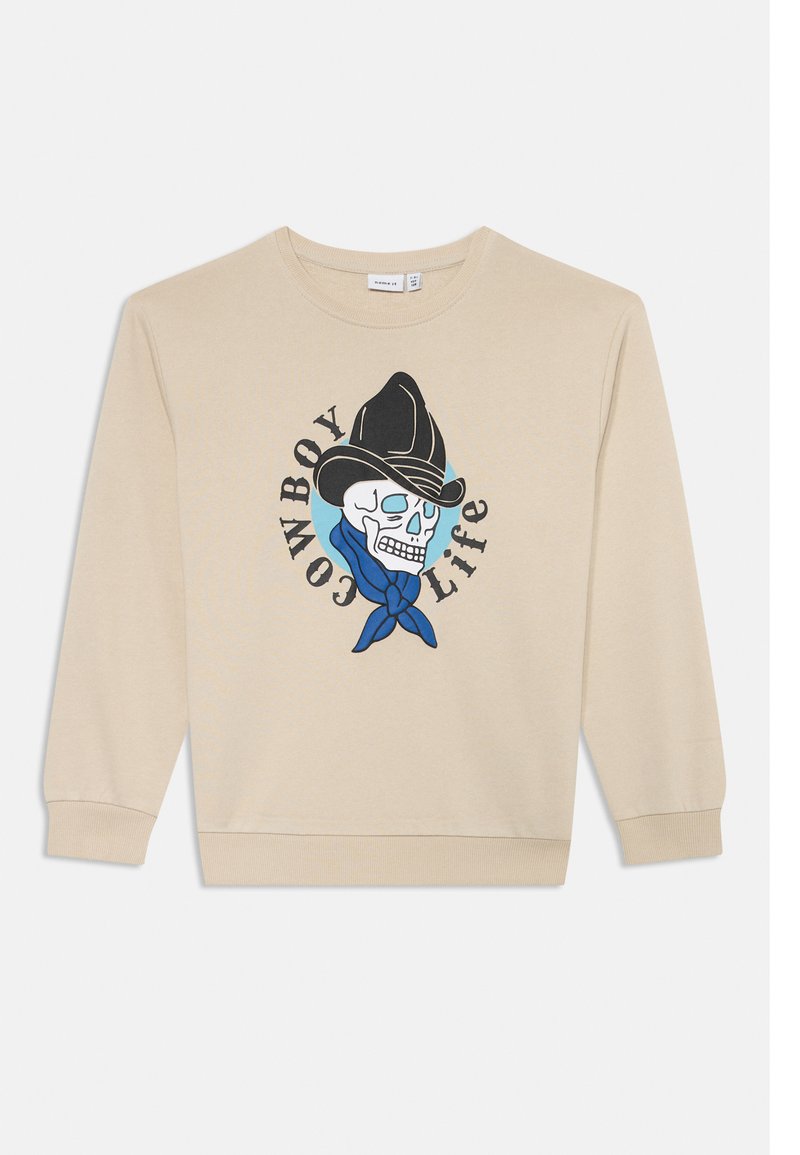 Sweat-shirt beige avec un motif de crâne portant un chapeau de cowboy noir et un bandana bleu, avec le texte "COWBOY LIFE" entourant le design.