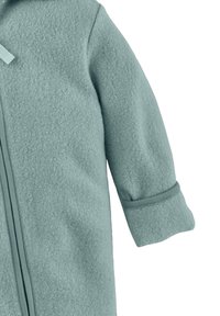 Lichtblauwe fleece buitenkleding met een rits, opgerolde mouwen en een zachte textuur. Voorzien van een capuchon en contrasterende bies langs de rits.