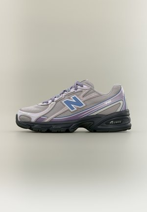 Light gray and lavender New Balance running shoe with black sole and purple laces, side view on plain beige background.