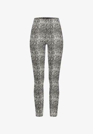 Sort og hvide leggings med et struktureret slangemønster, der har en tætsiddende design og elastisk talje for optimal komfort.