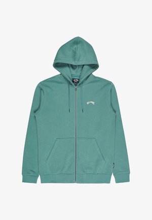 Grüner Zip-Hoodie aus weichem Stoff mit zwei Fronttaschen und Kapuze mit Kordelzug. Logo auf der linken Brustseite.