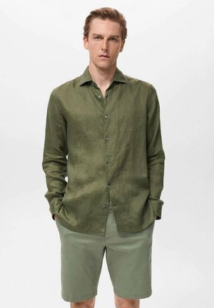 Green linen shirt with long sleeves and a button-down front, paired with light green shorts. Smooth texture and casual design.