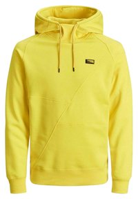 Žlutá mikina s kapucí vyrobená z bavlněné směsi. Má kapuci, stahovací šňůrky, přední klokánkovou kapsu a diagonální švy.