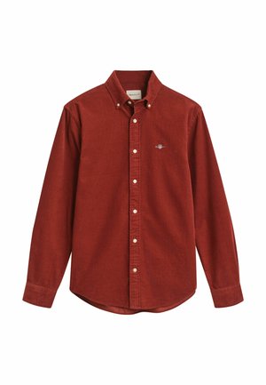 Rode corduroy knoopshirt met lange mouwen en een puntige kraag. Heeft een klein geborduurd logo op de borst en een gebogen zoom.