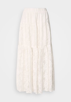 White lace maxi skirt with a tiered design, elastic waistband, and intricate floral patterns throughout. Lightweight and textured fabric.