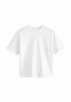 T-shirt blanc à manches courtes en coton. Il présente un col rond et une coupe décontractée avec une texture unie, sans motifs ni accents.