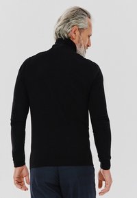 Czarny sweter z golfem, z długimi rękawami, dopasowany krój i żebrowane mankiety, wykonany z miękkiej, teksturowanej tkaniny. Sweter pokazany od tyłu.