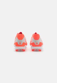 Soccer cleats with a predominantly gray upper, bright coral accents, textured finish, and white detailing on the sides.