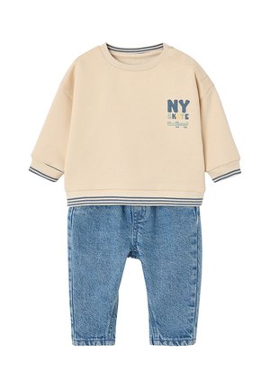 Beige long-sleeve baby sweater with "NY SKATE" text and blue striped cuffs paired with blue denim baby pants.