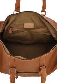 Tan leather duffel bag with a zippered closure, sturdy top handles, and a soft fabric interior featuring one zippered pocket.