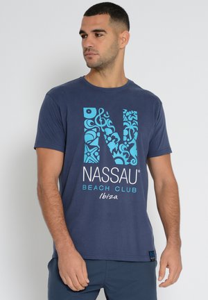 Navy blue short-sleeve t-shirt made of cotton, featuring a large turquoise graphic of "NASSAU BEACH CLUB" with intricate designs.