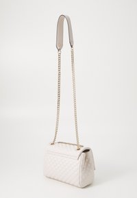 Quilted white leather handbag with a chain strap and a smooth top handle. Features a rectangular shape and subtle stitching detailing.