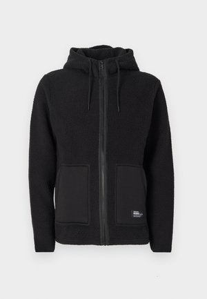 Black fleece jacket with a hood, featuring a full zipper, two front pockets, and textured fabric for warmth. Label on the bottom left side.